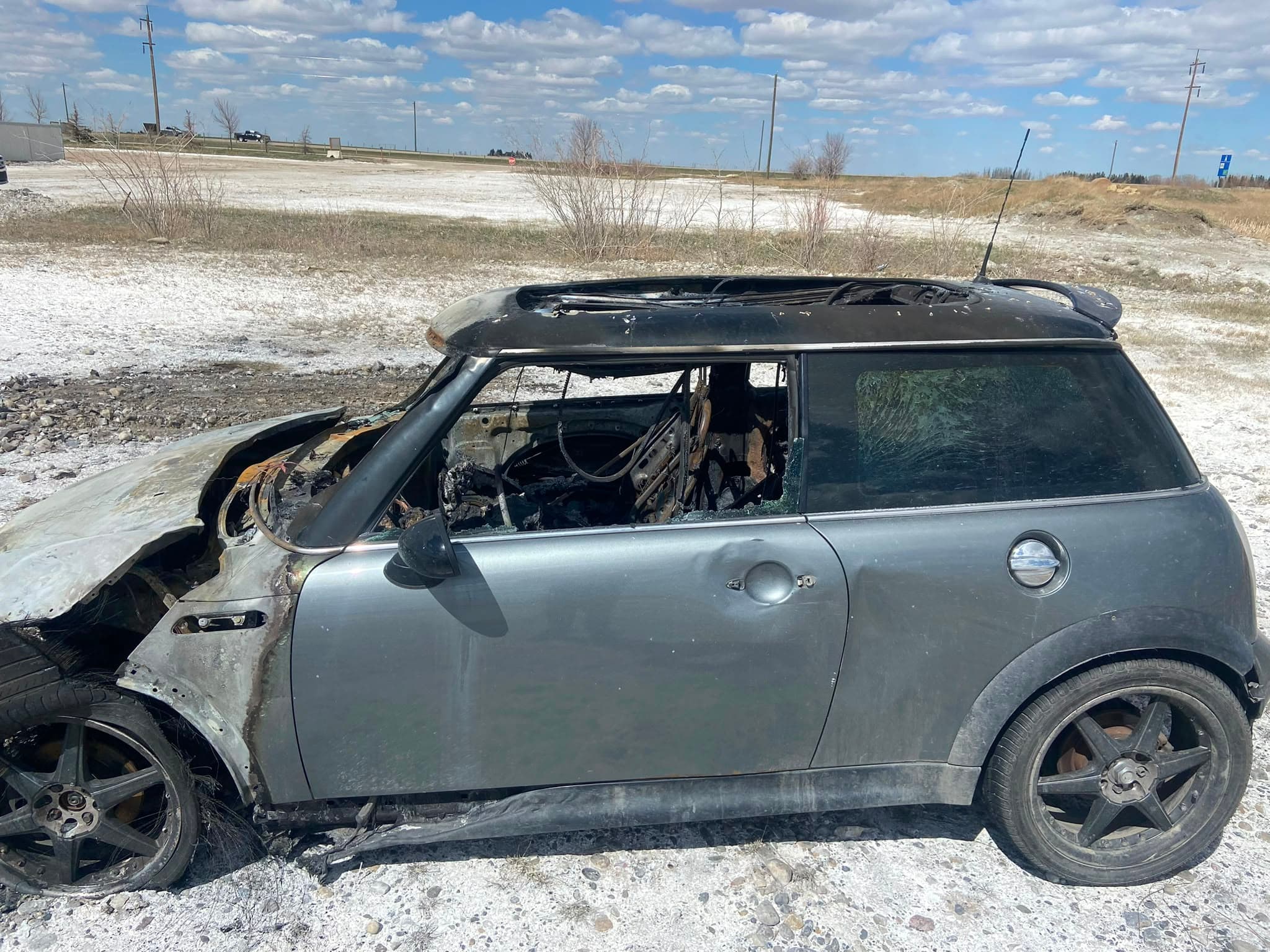 Fire-damaged vehicle requiring regulated fluid and hazardous-material recovery